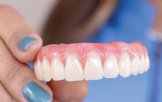 Dentures replace natural teeth with artificial teeth to improve smile and restore ability to chew, speak and bite properly.